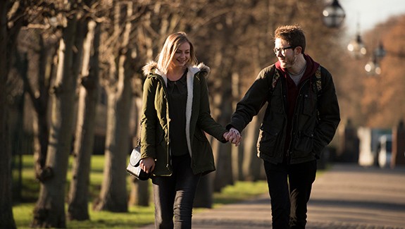 couple-holding-hands-walking-outdoors-with-healthy-skin-for-daily-life
